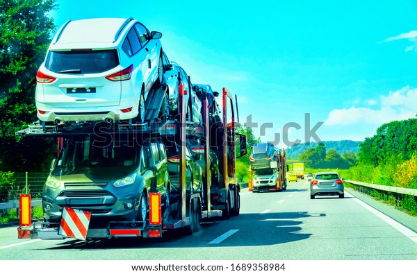 Car\
transporter truck on the road, in\
Switzerland.