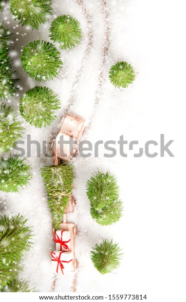 Car transporting gifts\
in the forest covered with snow. Christmas concept. White space for\
the text.