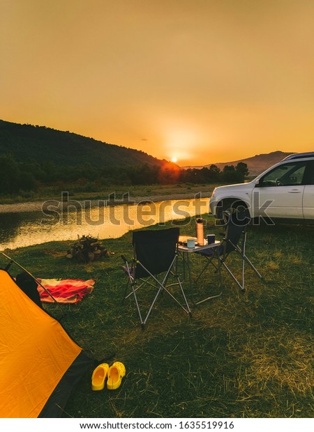 car\
travel concept, camping place near mountains\
river