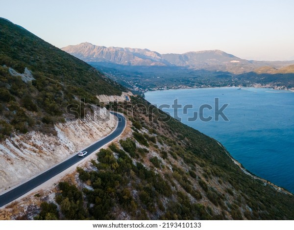 car travel concept moving by road in mountains\
with view of sea shore copy\
space