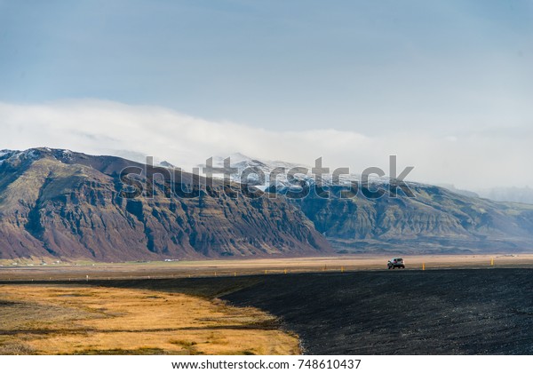 Car of the traveler driving with a scenic route\
in Iceland