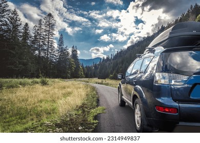 car for traveling with a mountain road. Blue sky - Shutterstock ID 2314949837