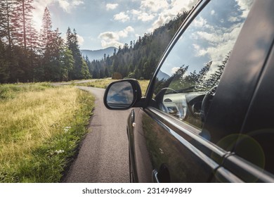 car for traveling with a mountain road. Blue sky - Shutterstock ID 2314949849