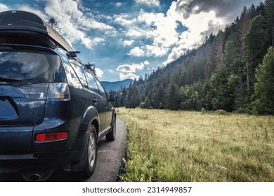 car for traveling with a mountain road. Blue sky - Shutterstock ID 2314949857