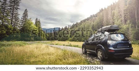 car for traveling with a mountain road. Blue sky
