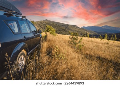 car for traveling with a mountain road. Dramatic sky - Shutterstock ID 2264439893