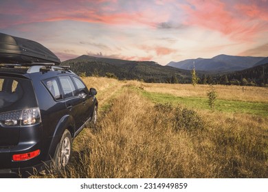 car for traveling with a mountain road. Dramatic sky - Shutterstock ID 2314949859