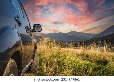 car for traveling with a mountain road. Dramatic sky - Shutterstock ID 2314949861