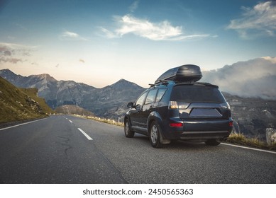 car for traveling with a mountain road. Dramatic sky - Powered by Shutterstock