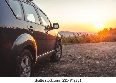 car for traveling with a mountain road. Sunset - Shutterstock ID 2314949851