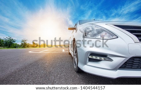 Car traveling in nature on an asphalt road - Front view - Image