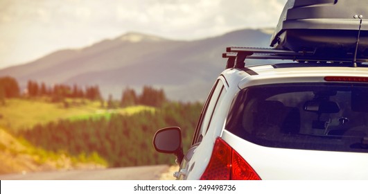 car for traveling with a roof rack on a mountain road - Shutterstock ID 249498736