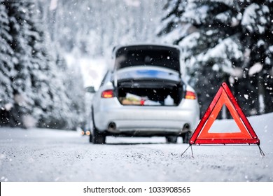 Car Trinagle On Highway With Broken Car In Winter. 