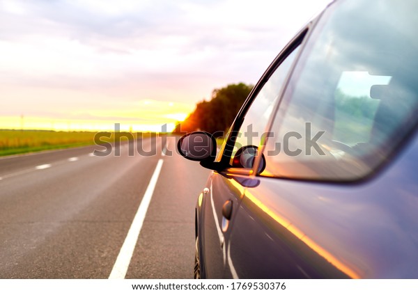 car trip
concept. part of a moving car at
sunset