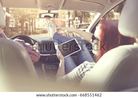 Similar – young women enjoying vacation in the car on road trip