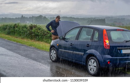 Car Trouble In The Rain. Broken Car.