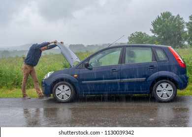 Car Trouble In The Rain. Broken Car.