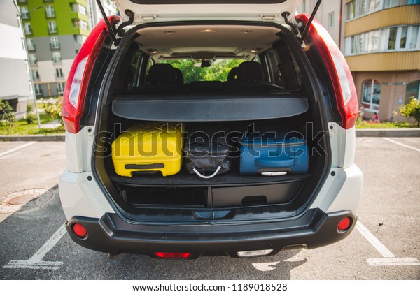 car\
trunk with loaded bags. car travel concept. road\
trip