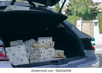 Car Trunk Open With Christmas Presents Ready To Put Under Christmas Tree At Home. Christmas Concept 2021-2022 