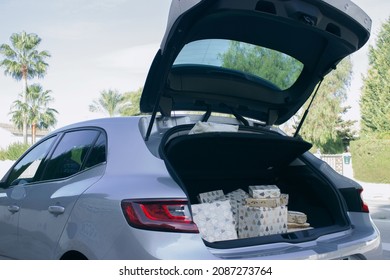 Car Trunk Open With Christmas Presents Ready To Put Under Christmas Tree At Home. Christmas Concept 2021-2022 