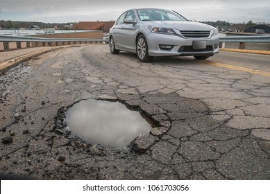 Car Trying To Avoid A Big Pothole