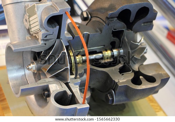 Car turbo motor kit in section, shaft with blade wheel\
rotor close up