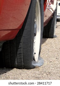 Car With Two Flat Tires On Roadside