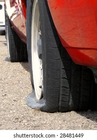 Car With Two Flat Tires On Roadside