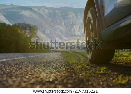 car tyre in the countryside road , double exposure image