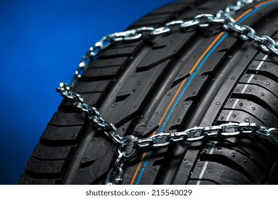 Car tyre with snow chain in the winter 