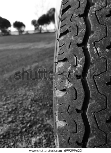 A car tyre, though relatively new, looks messy with\
some mud on it.