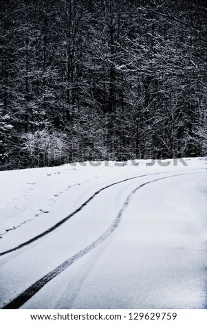 Car tyre traces on a mountain curved road