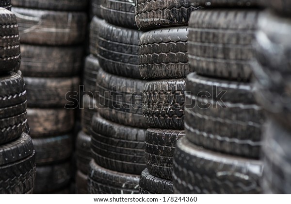 Car tyres\
stacked in a tyre distribution\
centre