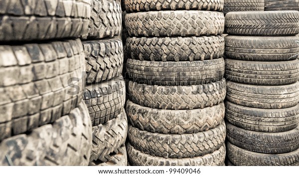 Car tyres stacked in a tyre distribution centre.\
Selective focus.