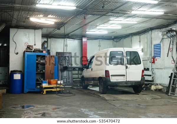 Car under repair in a\
car repair shop