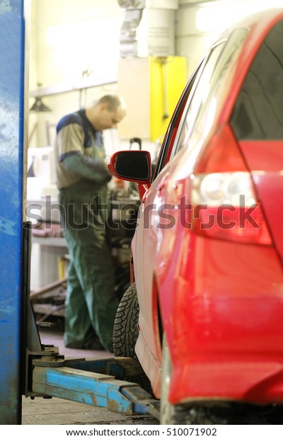 Car under repair in\
a car repair station