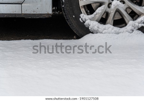 A car under the snow.\
Snow and ice on cars after extreme snowfall in the town. Winter\
town scene. The car on the street is covered in ice rain.\
Snow-covered vehicles.