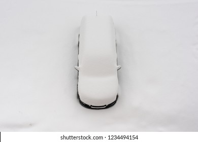 Car Under The Snow, View From Above. Heavy Snow In The City.