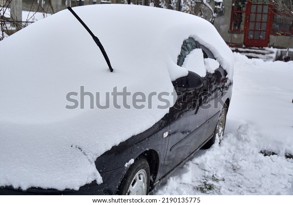 Car under the\
snow., winter weather vehicle. Cars blocked by snow on roads,\
street snow-paralysis of\
traffic.