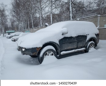 Car Under A Thick Layer Of Snow. Winter In Russia