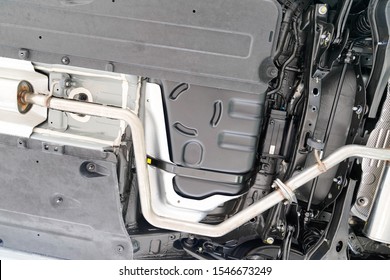 Car Undercarriage On Lift In Workshop Station During Repairs