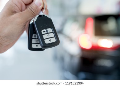 Car valet parking service business concept with people handling car key on blur parking lot background