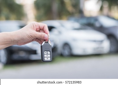 Car Valet Parking Service Business Concept With People Handling Car Key On Blur Parking Lot Background