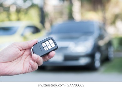 Car Valet Parking Service Business Concept With People Handling Car Key On Blur Parking Lot Background