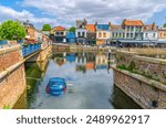 Car vehicle drown sink in water of canal Somme near Pont de la Dodane bridge of Amiens historical city centre Saint-Leu quarter, embankment promenade Quai Belu, Hauts-de-France Region, France