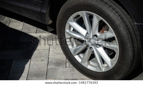 Car vehicle one wheel disk tire dirty dusty close up\
side view