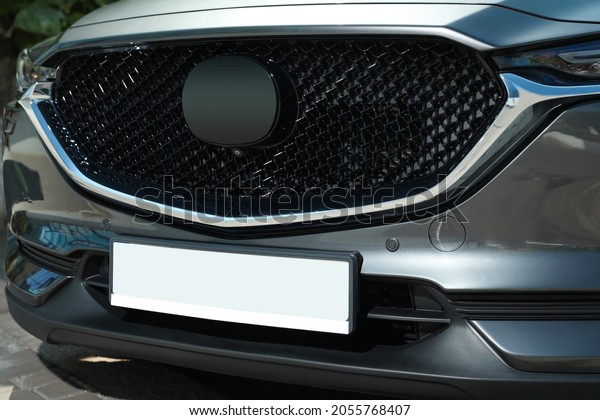 Car\
with vehicle registration plate outdoors,\
closeup