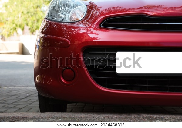 Car\
with vehicle registration plate outdoors,\
closeup