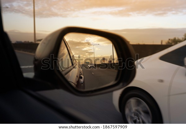 car view\
mirror on sunset. sunset car driving\
scene.