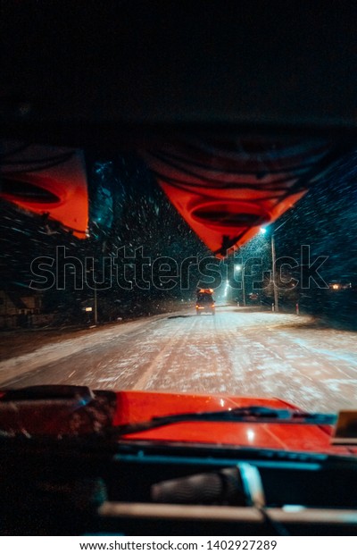 In car\
view of snowfall storm on the countryside\
road